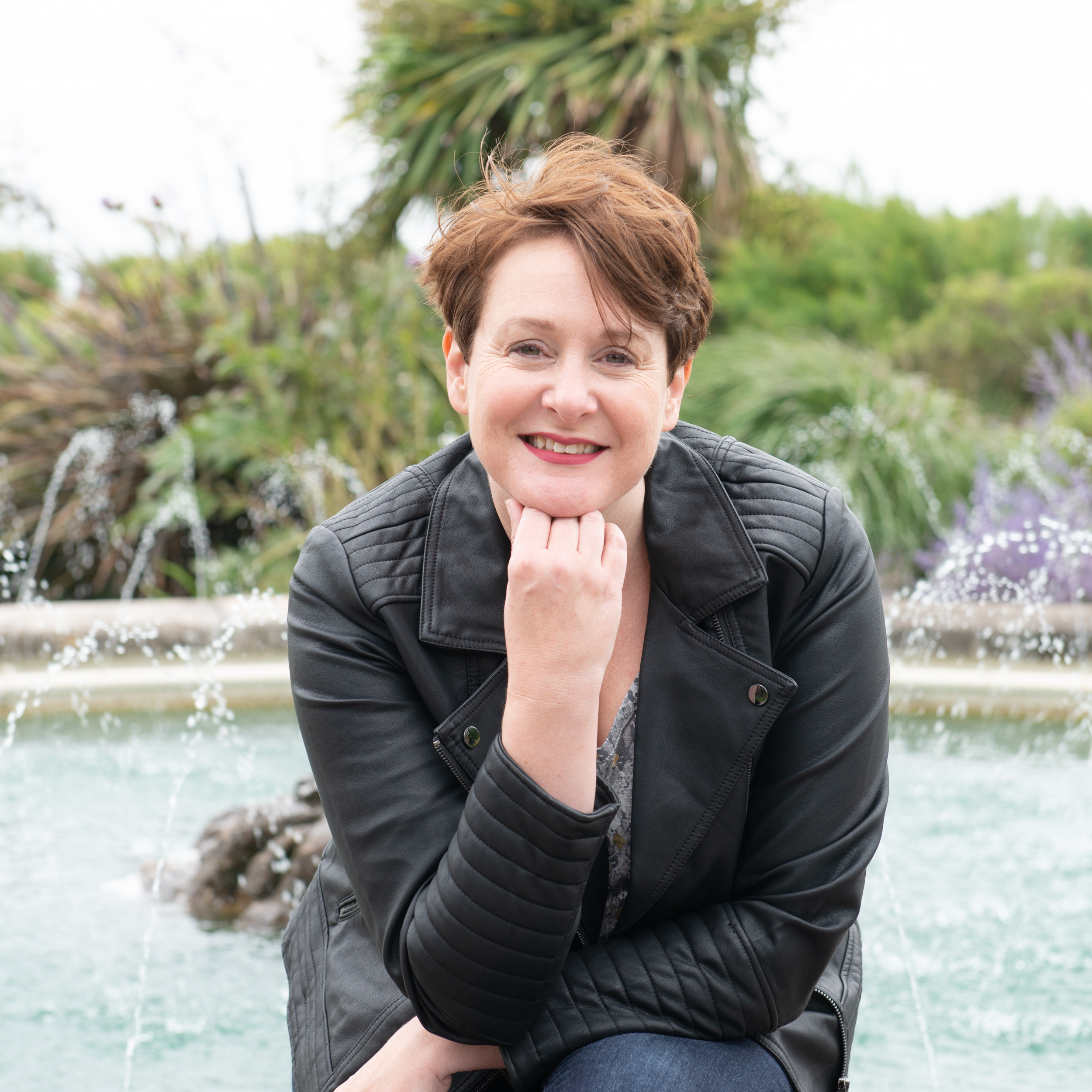 Catherine Jones copywriter and writing coach sat by a fountain in Bognor Regis, West Sussex, UK